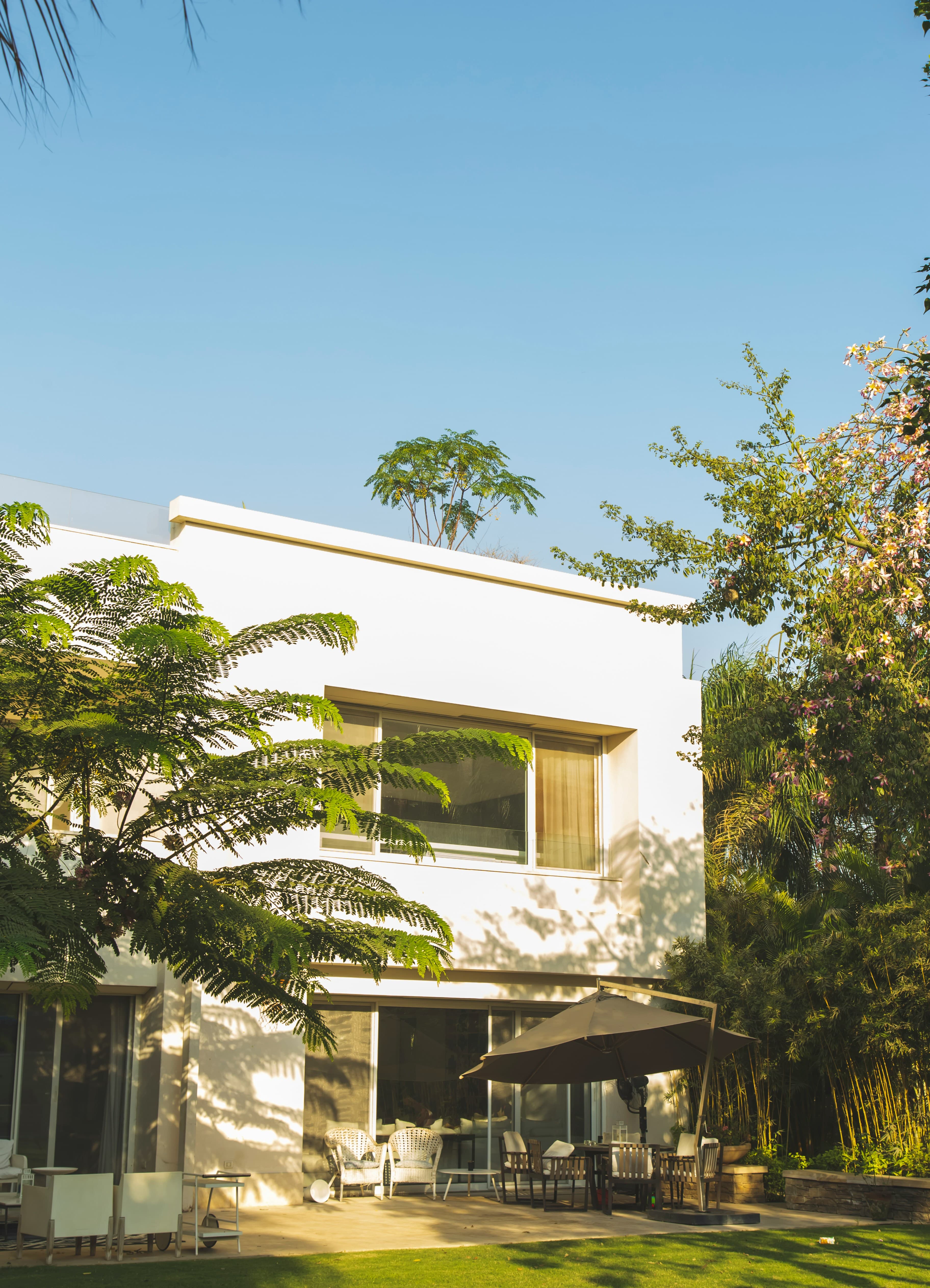White villa in a lush garden at golden hour