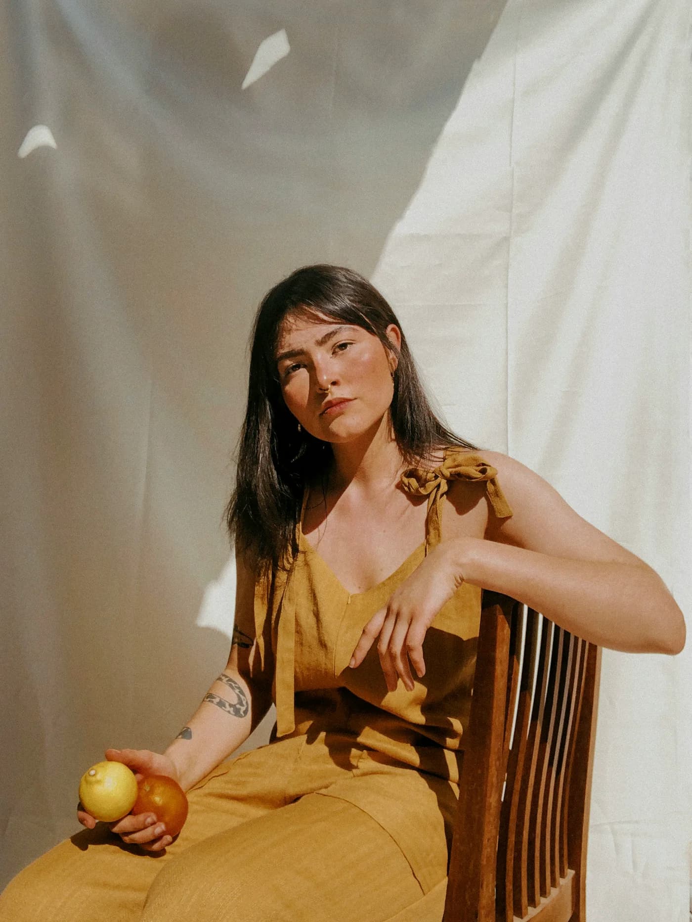 Portrait in a mustard linen set against a studio drape