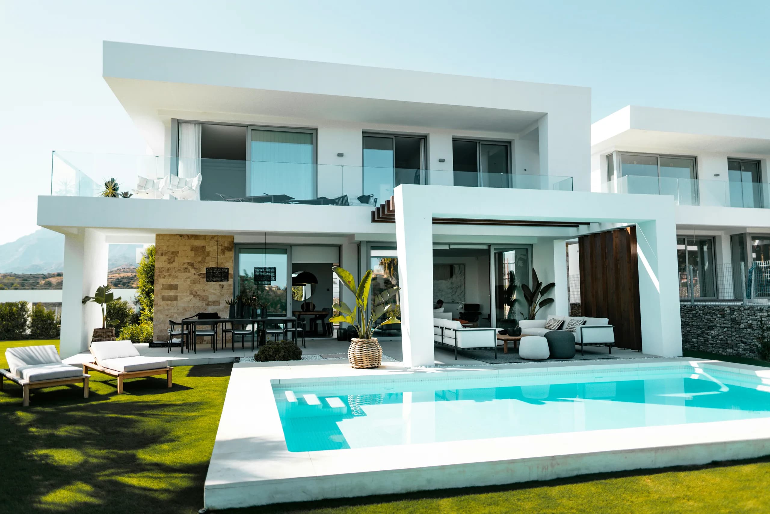 Modern white villa with a private pool in bright daylight